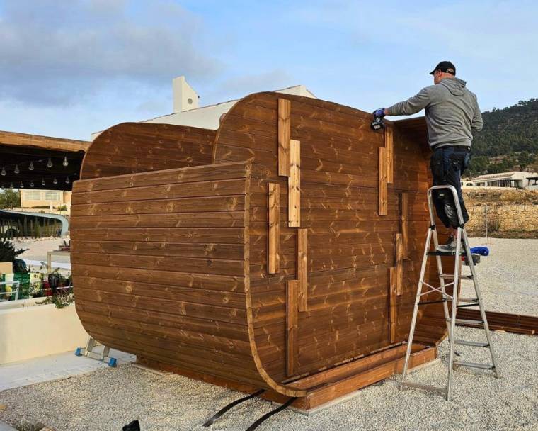 Cubus sauna with wood burning heater assembly